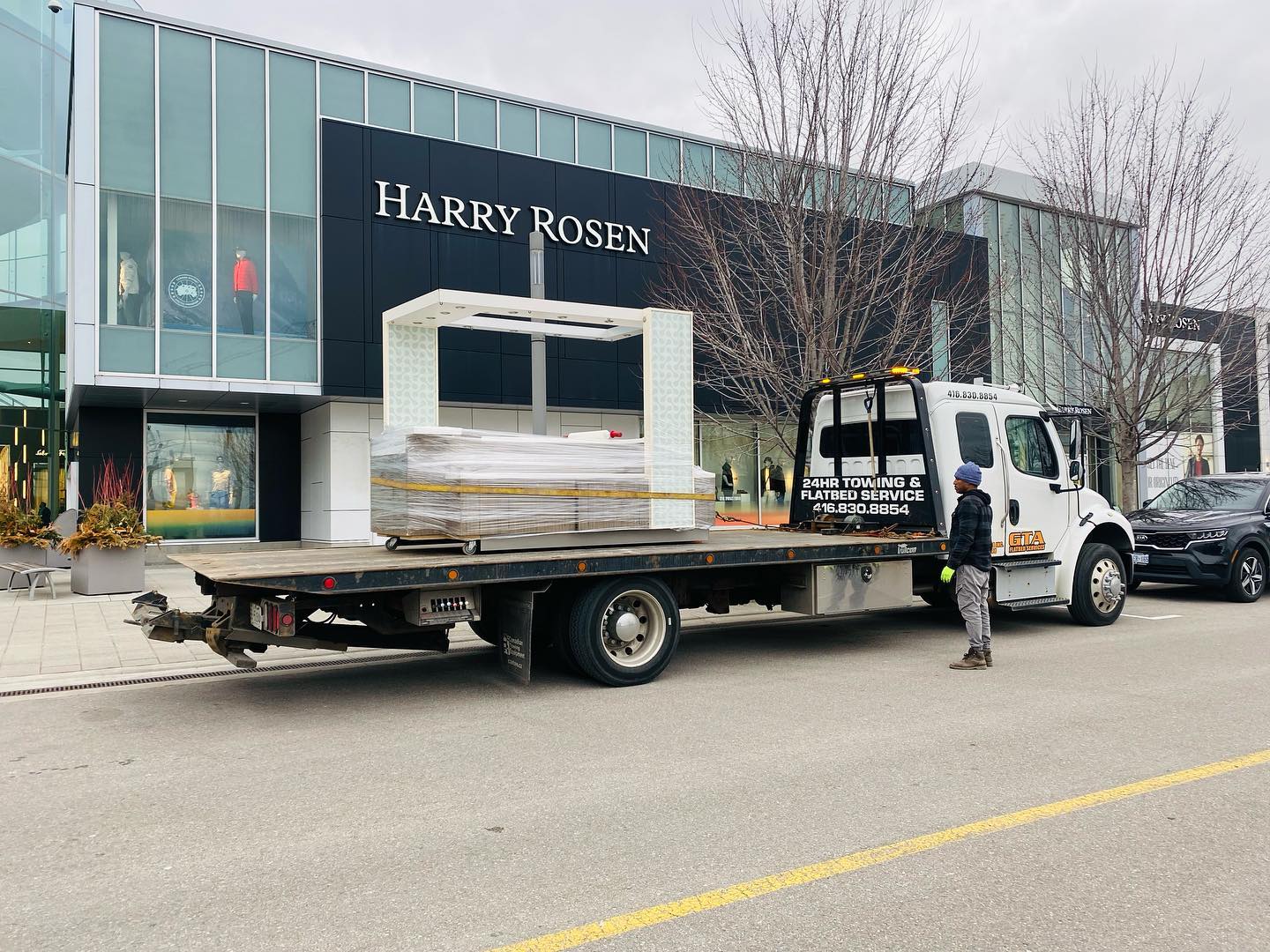 Store fixtures on a flatbed truck outside a retail store